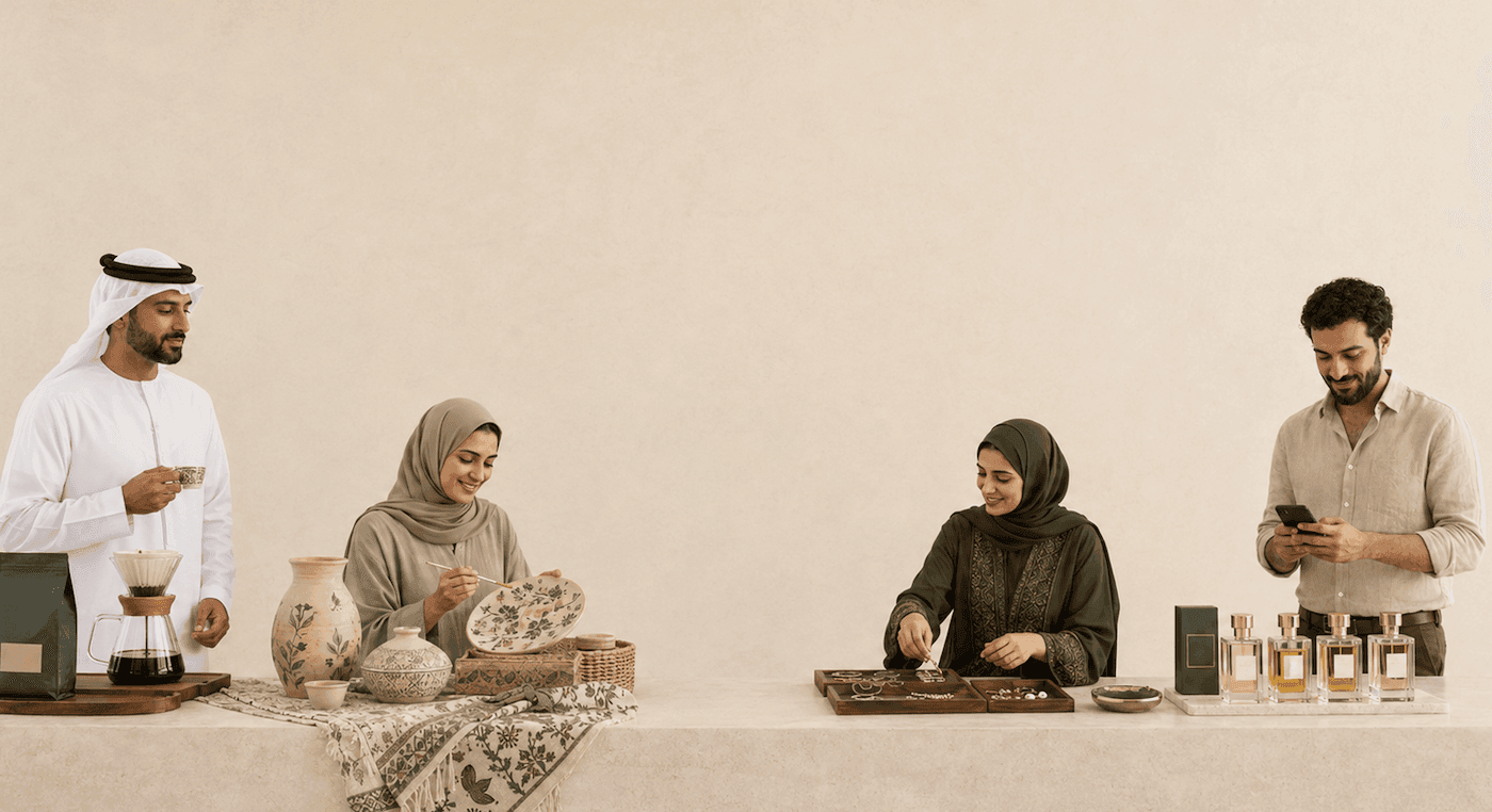 Local artisans — a coffee roaster, a potter, a jeweller, and a perfumer — at work along a long stone table